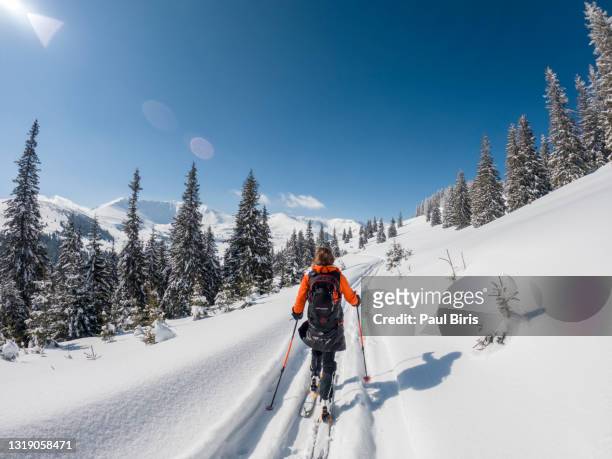 adventurous woman on skies, ski touring in the snowy mountains. active adult in winter mountains. - beautiful romanian women stock pictures, royalty-free photos & images
