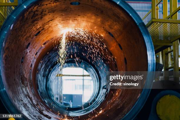 electric welding in factory - construction circle stockfoto's en -beelden