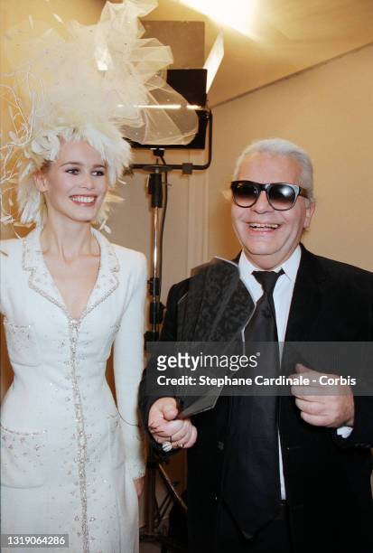 Top Model Claudia Schiffer and Fashion designer Karl Lagerfeld pose backstage during the Chanel Haute Couture Spring/Summer 1996 show as part of...