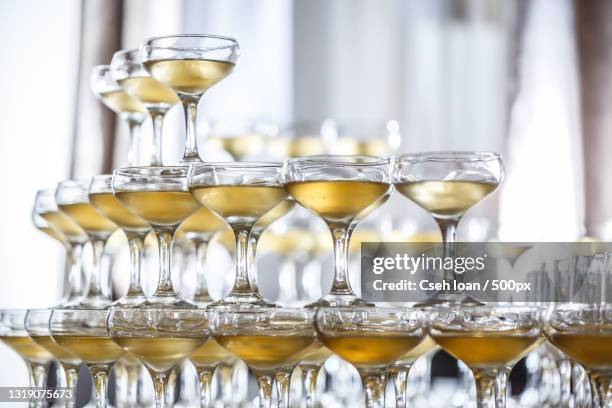 close-up of wine glasses on table - champagne pyramid stockfoto's en -beelden