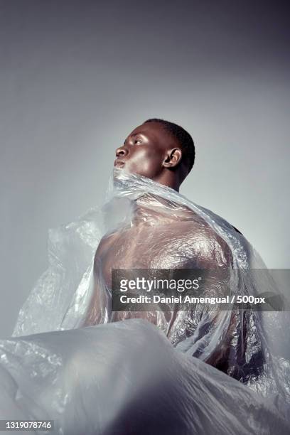 portrait of a young man covered with plastic,palma,islas baleares,spain - editorial fotografías e imágenes de stock