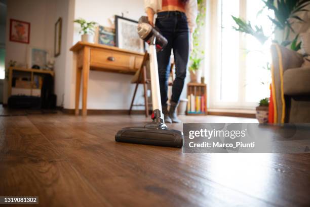 woman cleaning with vacuum cleaner - vacuum cleaner stock pictures, royalty-free photos & images