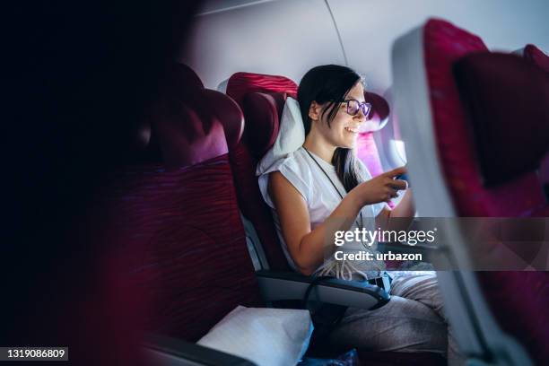 reading news or messages on an airplane - wonderlust computer stock pictures, royalty-free photos & images