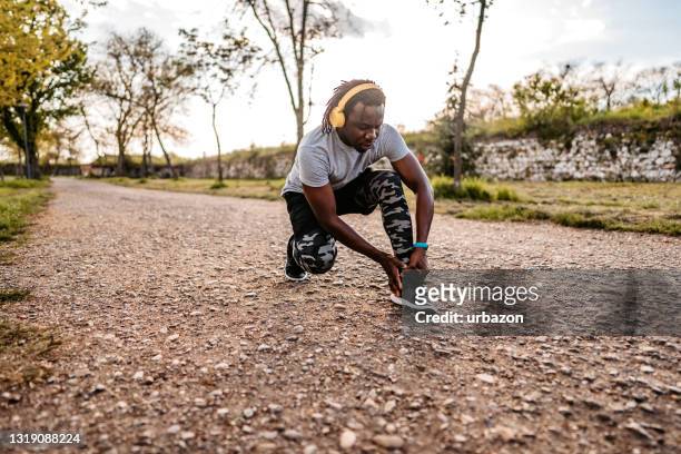 sportsman hurting his ankle during running - muscle cramps stock pictures, royalty-free photos & images