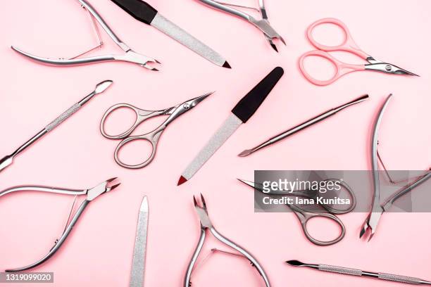 set of manicure tools on trendy pastel pink background. nail files, scissors, cuticle clippers. - nail clippers stock pictures, royalty-free photos & images