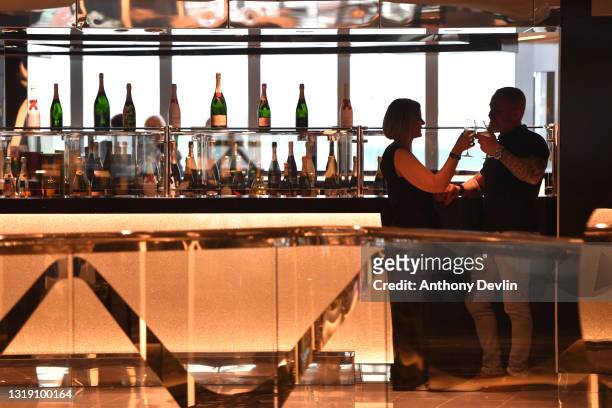 Guests relax in the champagne bar during the first sailing of brand new ship MSC Virtuosa, the first cruise to depart the UK since lockdown on May...