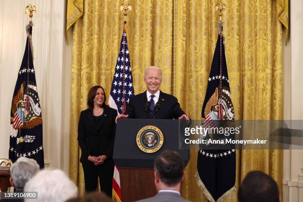 President Joe Biden laughs while giving remarks, as Vice President Kamala Harris looks on, before a signing ceremony for the COVID-19 Hate Crimes Act...