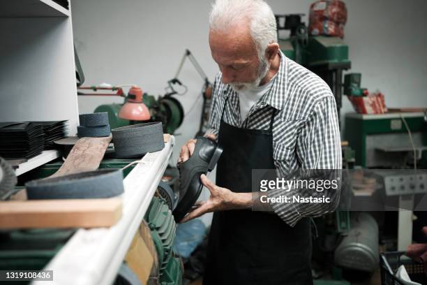 shoemaker grinding shoe on grinding machine - suede shoe stock pictures, royalty-free photos & images