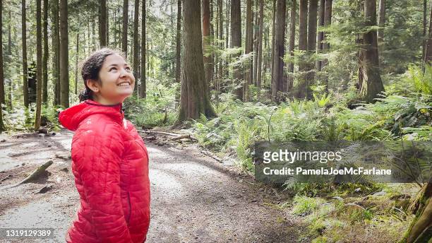 young solo eurasian woman hiking and enjoying forest view - forest bathing stock pictures, royalty-free photos & images
