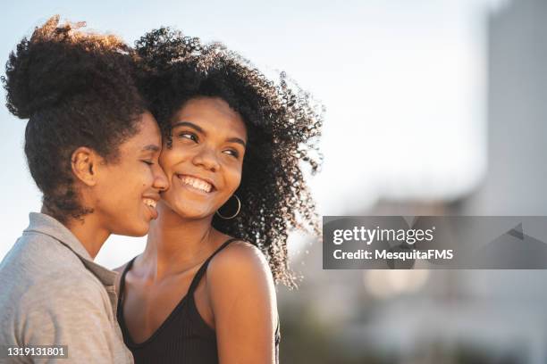 portrait of lesbian couple dating outdoors - images of lesbians kissing stock pictures, royalty-free photos & images