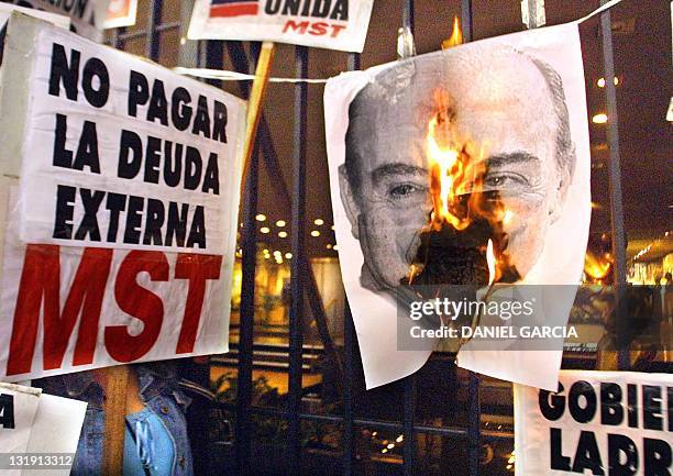 Militants burn an image of Economic Minister Domingo Cavallo 13 December 2001 in Buenos Aires, Argentina during a general strike called by the...