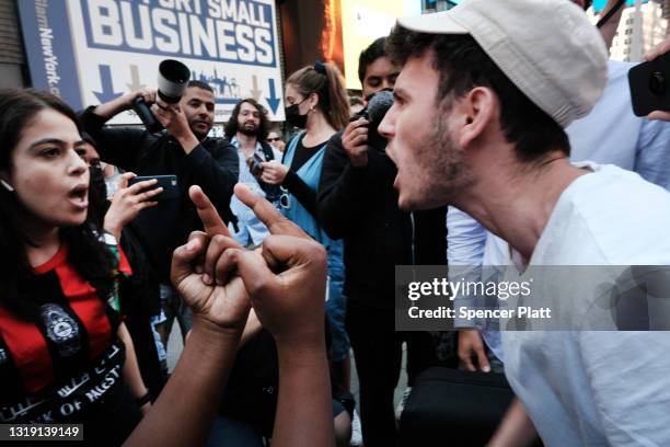 Pro Palestinian protesters face off with a group of Israel supporters and police in a violent clash in Times Square on May 20, 2021 in New York City....