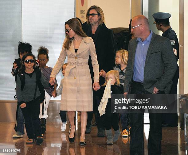 Accompanied by their children, US movie star Brad Pitt and Angellina Jolie appear before photographers upon their arrival at Haneda Airport in Tokyo...