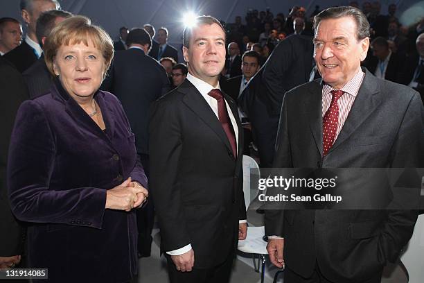 German Chancellor Angela Merkel, Russian President Dmitry Medvedev and former German Chancellor Gerhard Schroeder arrive for a ceremony to inaugurate...