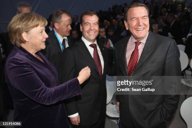 German Chancellor Angela Merkel, Russian President Dmitry Medvedev and former German Chancellor Gerhard Schroeder arrive for a ceremony to inaugurate...