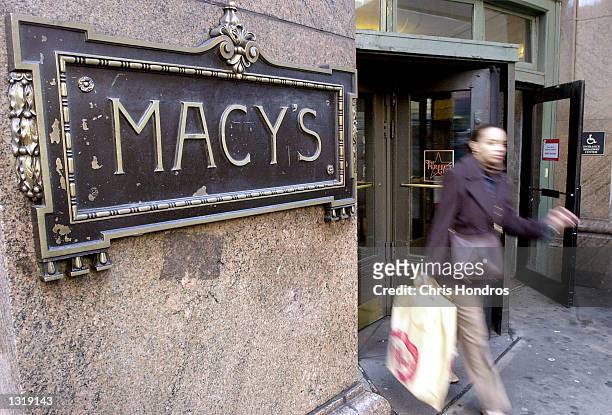 Woman exits Macy''s department store on Sixth Avenue December 14, 2000 in New York. The holiday shopping season is in full swing, bringing thousands...