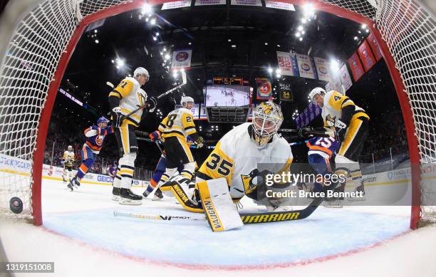 Cal Clutterbuck of the New York Islanders scores at 14:17 of the third period against Tristan Jarry of the Pittsburgh Penguins in Game Three of the...