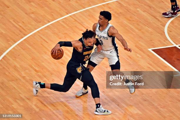 Dillon Brooks of the Memphis Grizzlies handles the ball against Keldon Johnson of the San Antonio Spurs during the game of the play-in tournament...