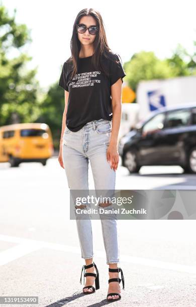 Model Cassady Smith is seen wearing a black vintage top, Abercrombie blue jeans, black shoes and Target sunglasses on May 20, 2021 in New York City.