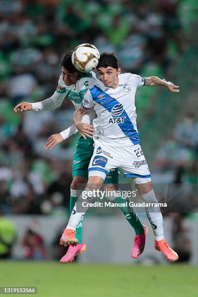 Omar Campos of Santos struggles for the ball with Omar Fernandez of Puebla during the semifinals first leg match between Santos Laguna and Puebla as...