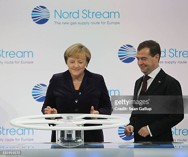 German Chancellor Angela Merkel and Russian President Dmitry Medvedev arrive to turn a wheel with other European leaders to symbolically start the...
