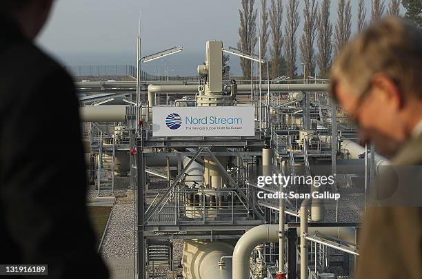 Visitors look out at the central facility where the Nord Stream Baltic Sea gas pipeline reaches western Europe following the pipeline's official...