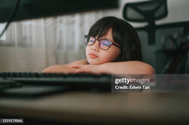 asian chinese young girl taking a nap fall asleep during e learning using desktop pc at home - e girls stock pictures, royalty-free photos & images