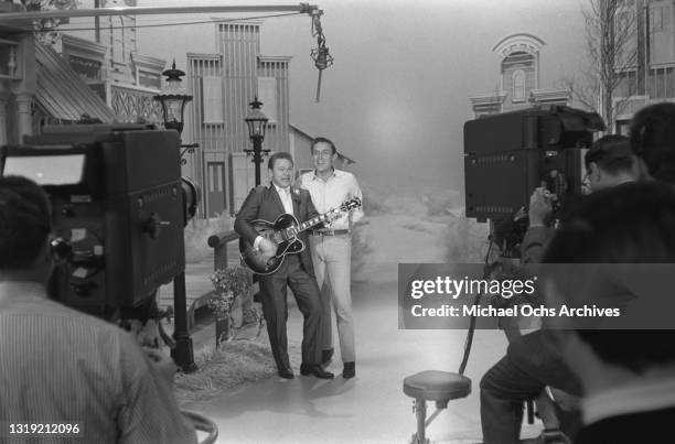 American singer and musician Roy Clark , playing a Gibson Byrdland guitar, and American country music singer and television host Jimmy Dean on the...