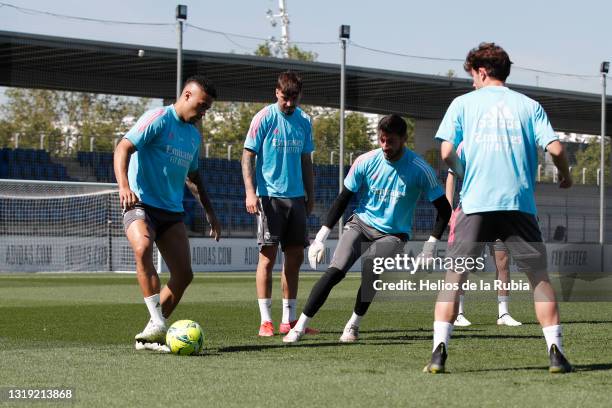 Mariano Díaz and Diego Altube both of Real Madrid are training with teammate Álvaro Odriozola at Valdebebas training ground on May 21, 2021 in...