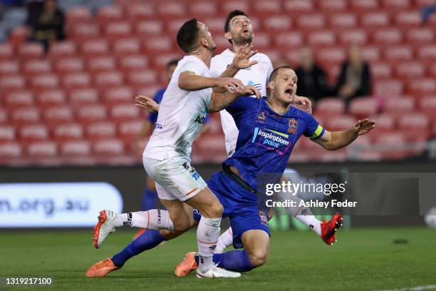 Nigel Boogaard of the Jets is tackled by Jay O'Shea of the Roar during the A-League match between Newcastle Jets and Brisbane Roar at McDonald Jones...