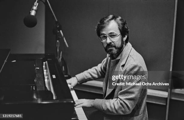 American pianist, arranger, and record producer Bob James playing the piano in an unspecified recording studio, location unspecified, circa 1975.