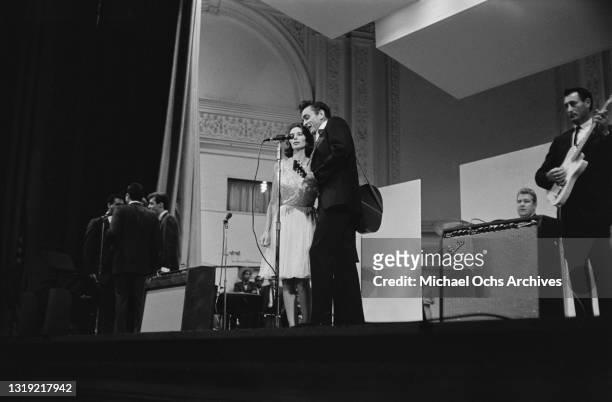 American singer-songwriter and musician June Carter Cash with her husband, American singer-songwriter and musician Johnny Cash on stage with Johnny's...