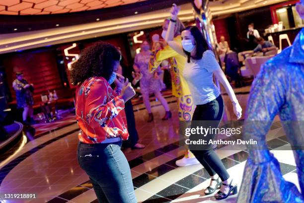 Guests dance as a live band plays during the first sailing of brand new ship MSC Virtuosa, the first cruise to depart the UK since lockdown on May...