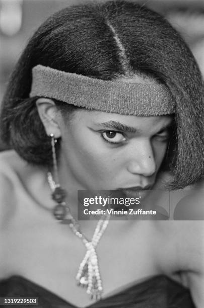 Young person wearing a dress with a sweetheart neckline, with a headband, location unspecified, January 1981.