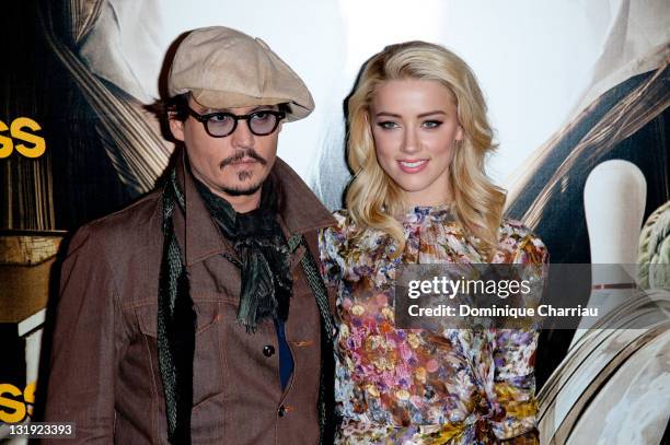 Johnny Depp and Amber Heard pose during the 'Rhum Express' Photocall at Hotel Paris Plaza Athenee on November 8, 2011 in Paris, France.