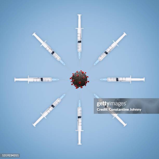 covid-19 vaccination concepts. syringes in arranged in circle fighting against virus. - fighting covid stock pictures, royalty-free photos & images