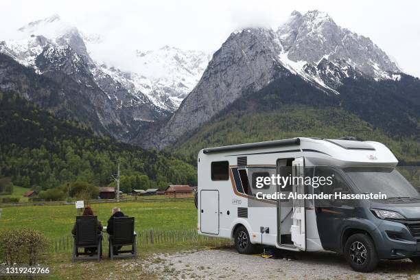 People enjoy the atmosphere at motorhome campsite "Camping Resort Zuspitze" in front of Germany's highest peak "Zugspitze" on the first day of the...