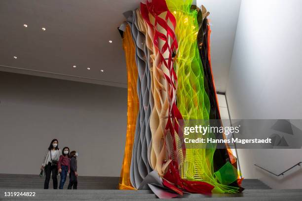 Visitors wearing face masks at the Pinakothek der Moderne on May 21, 2021 in Munich, Germany. Museum and cultural spaces across Germany have reopened...