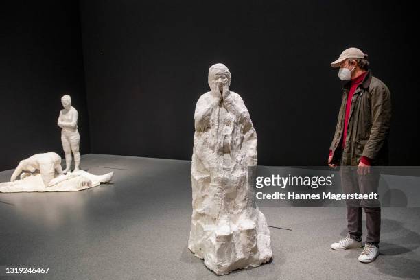 Visitors wearing face masks during the exhibition of the artist George Segal at the Pinakothek der Moderne on May 21, 2021 in Munich, Germany. Museum...