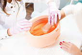 process paraffin treatment of female hands in beauty salon