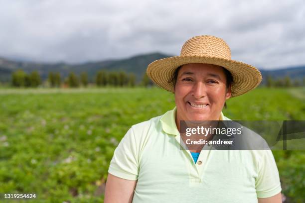 portrait of a latin american woman working in agriculture at a farm - farm worker stock pictures, royalty-free photos & images