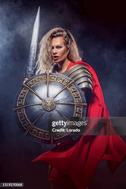 a female warrior gladiator holding a weapon - gladiator armour stock pictures, royalty-free photos & images