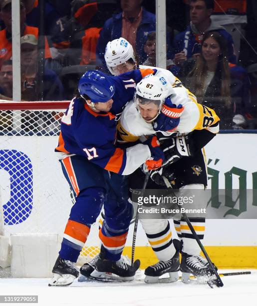 Sidney Crosby of the Pittsburgh Penguins and Matt Martin of the New York Islanders tangle in Game Three of the First Round of the 2021 Stanley Cup...