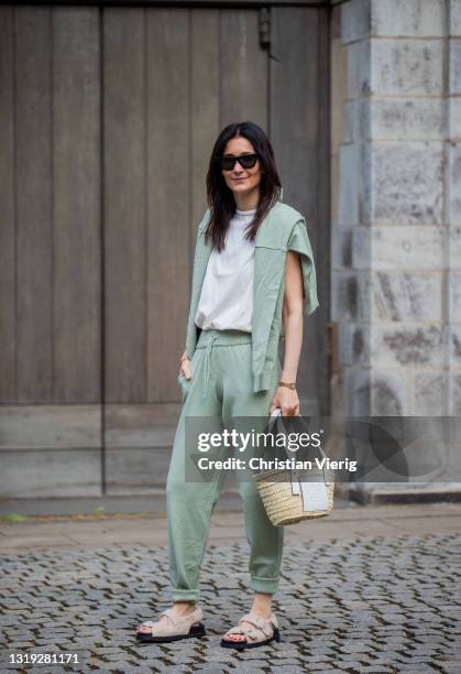 Golestaneh Mayer-Uellner is seen wearing jogging suit in green Zara, white padded muscle shirt Zar, dad sandals Zara, basket bag Loewe, sunglasses...