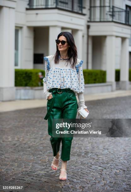 Golestaneh Mayer-Uellner is seen wearing white blue blouse Zimmermann, green leather paperbag pants Petar Petrov, white mid heel sandals The Row,...