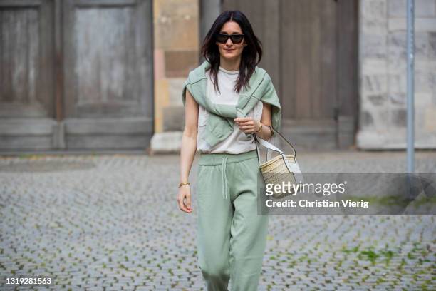 Golestaneh Mayer-Uellner is seen wearing jogging suit in green Zara, white padded muscle shirt Zar, dad sandals Zara, basket bag Loewe, sunglasses...