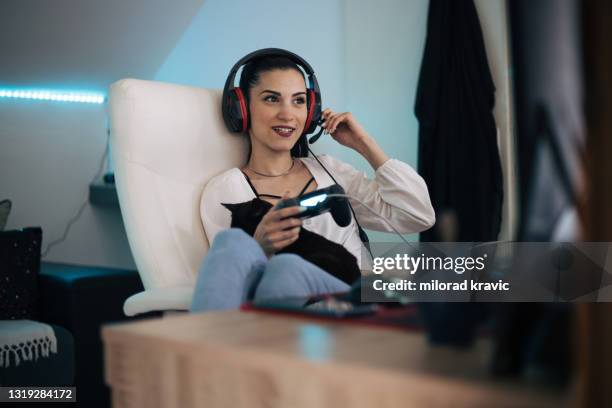 young woman playing computer game - net sports equipment stock pictures, royalty-free photos & images