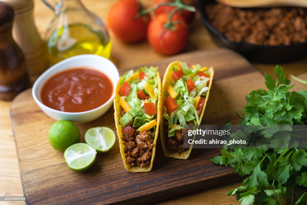 Hard shell taco on wooden board with lime