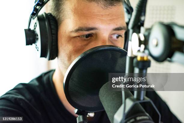 handsome male radio host in studio - radio host stock pictures, royalty-free photos & images