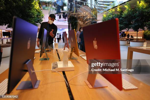 People look at recently released iMac color computers at the 5th Avenue Apple store on May 21, 2021 in New York City. Apple recently launched new...